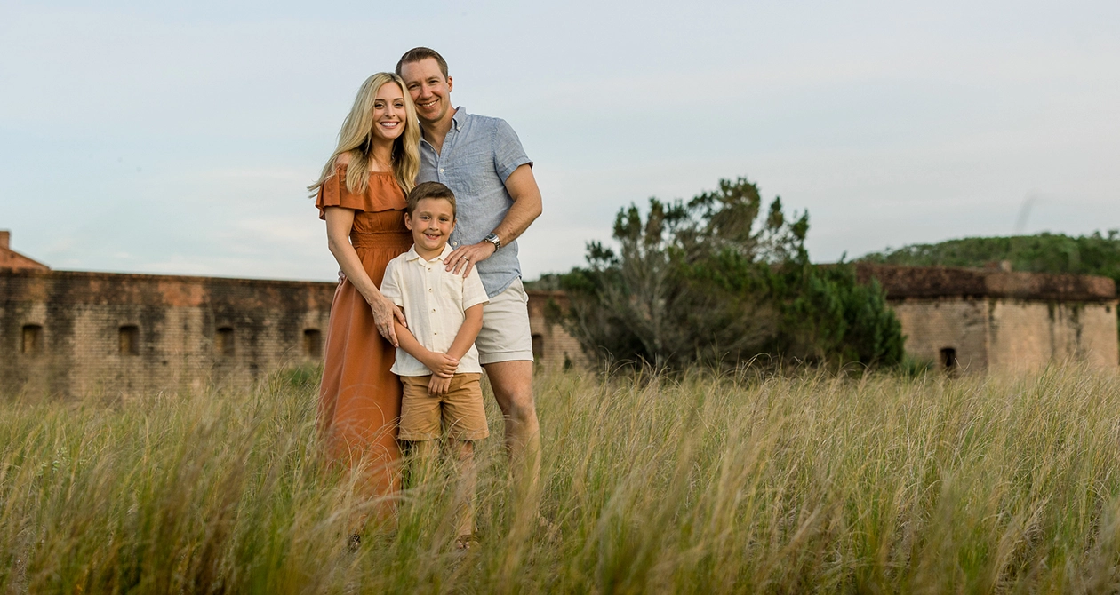 Family in field on beach