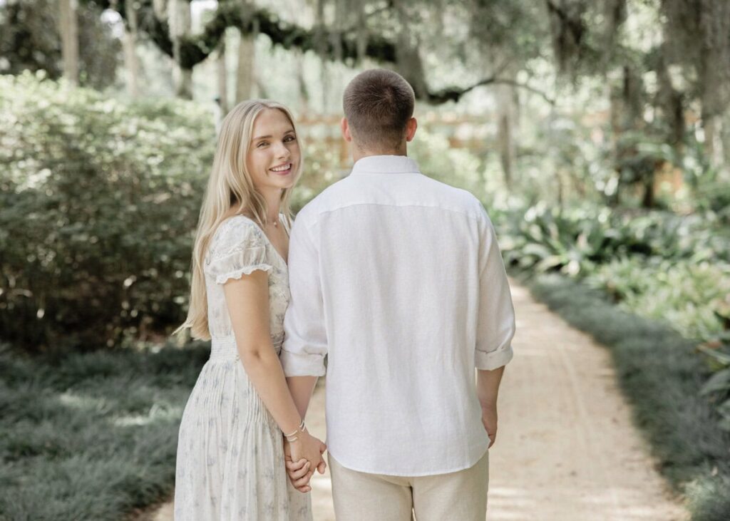 Couple walk through garden at Washington Oaks Gardens Engagement Photos